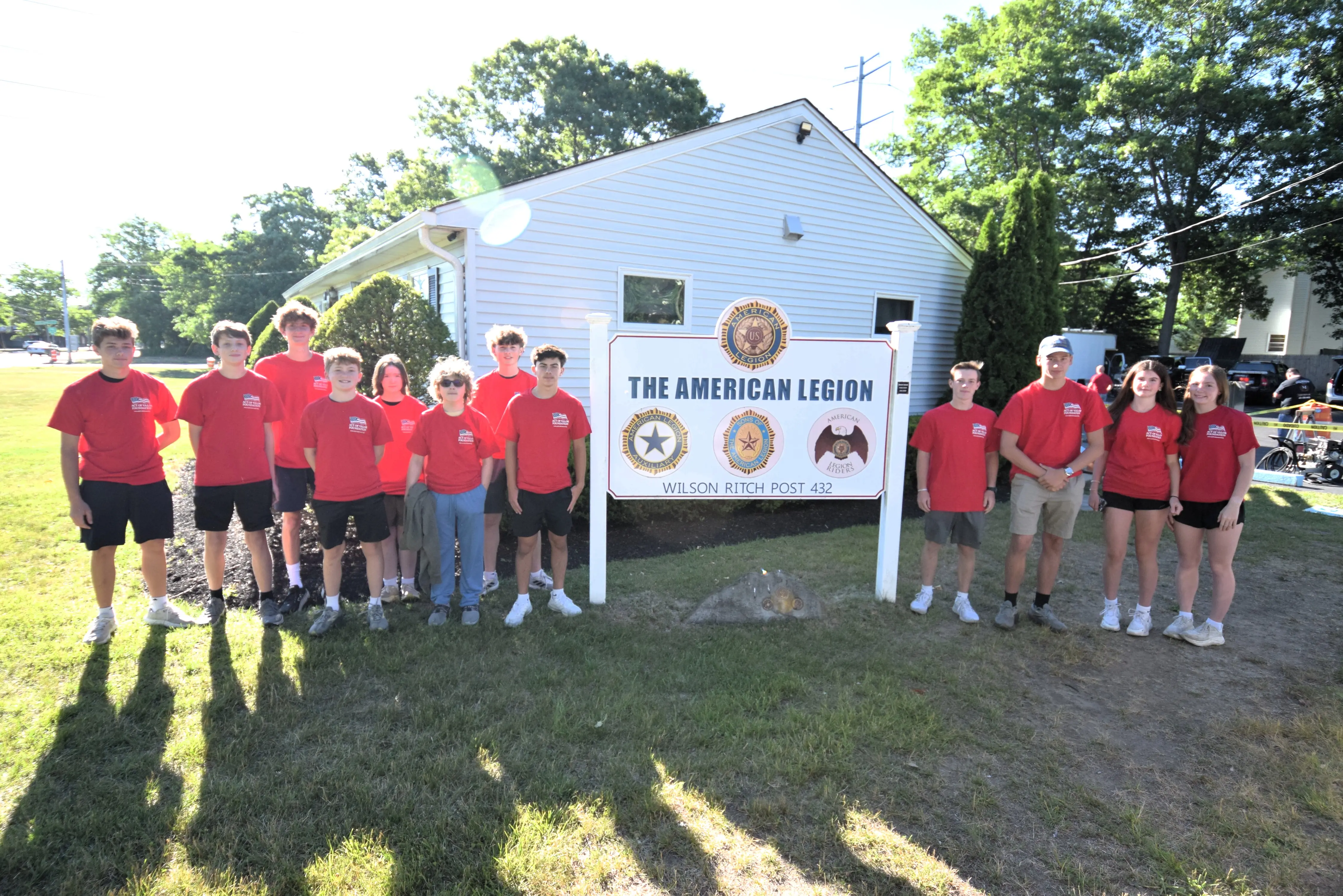 Act of Valor Foundation youth volunteers lined up in front of the American Legion Wilson Ritch Post 432 sign