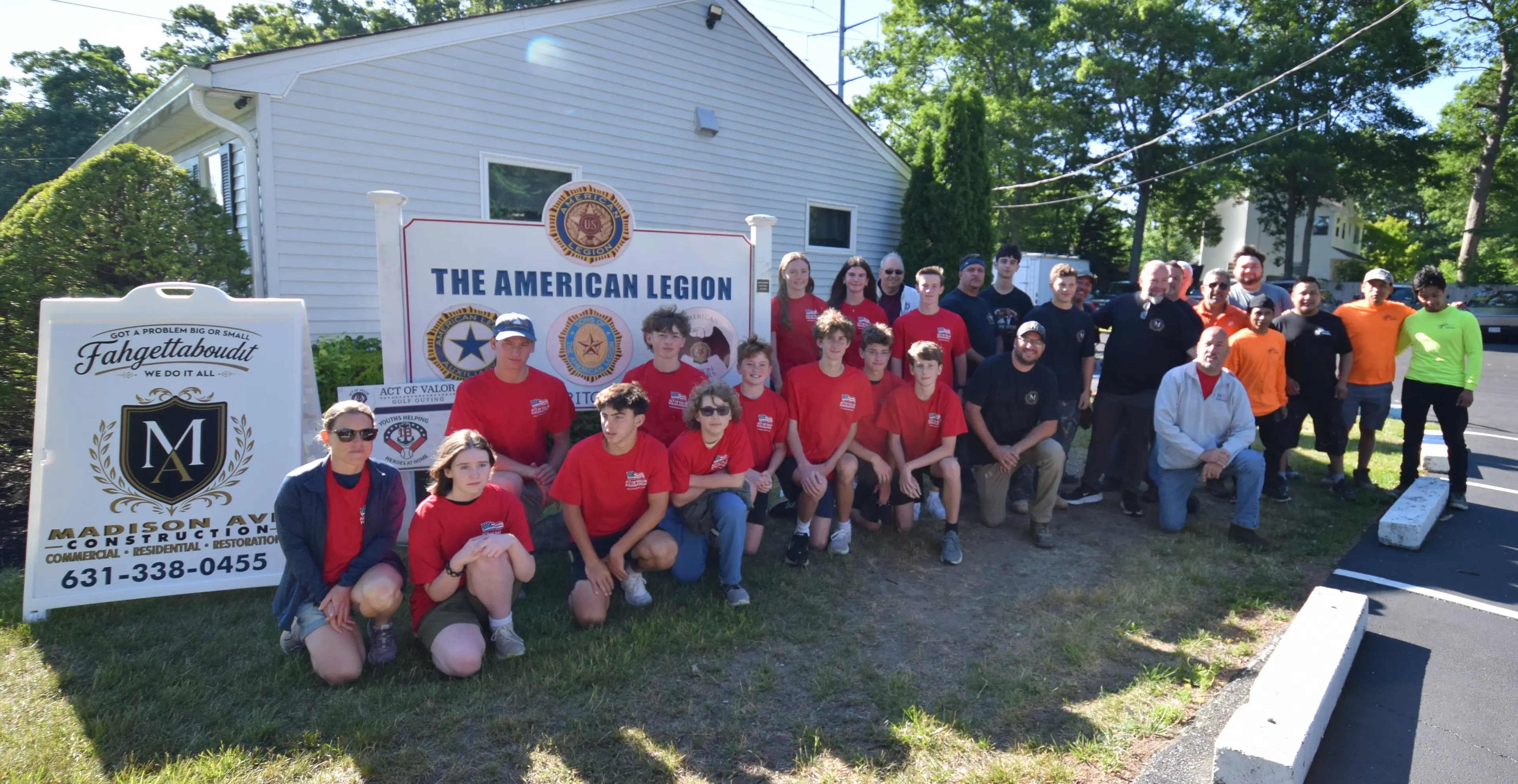 Madison Ave Construction crew, Act of Valor Foundation youth volunteers, and members gathered in front of the American Legion Wilson Ritch Post 432 sign