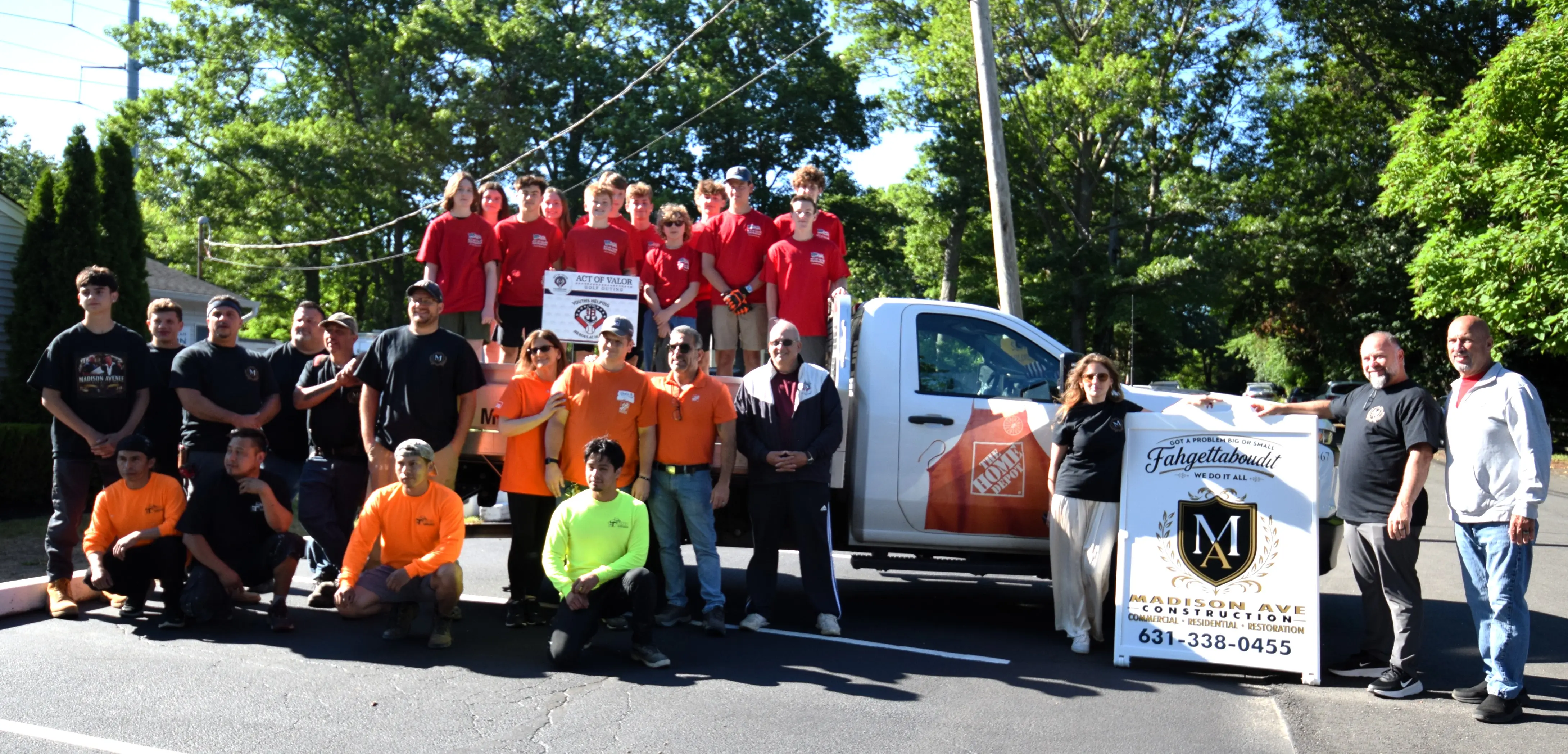 Madison Ave Construction crew and Act of Valor Foundation youth volunteers with the company truck at the American Legion