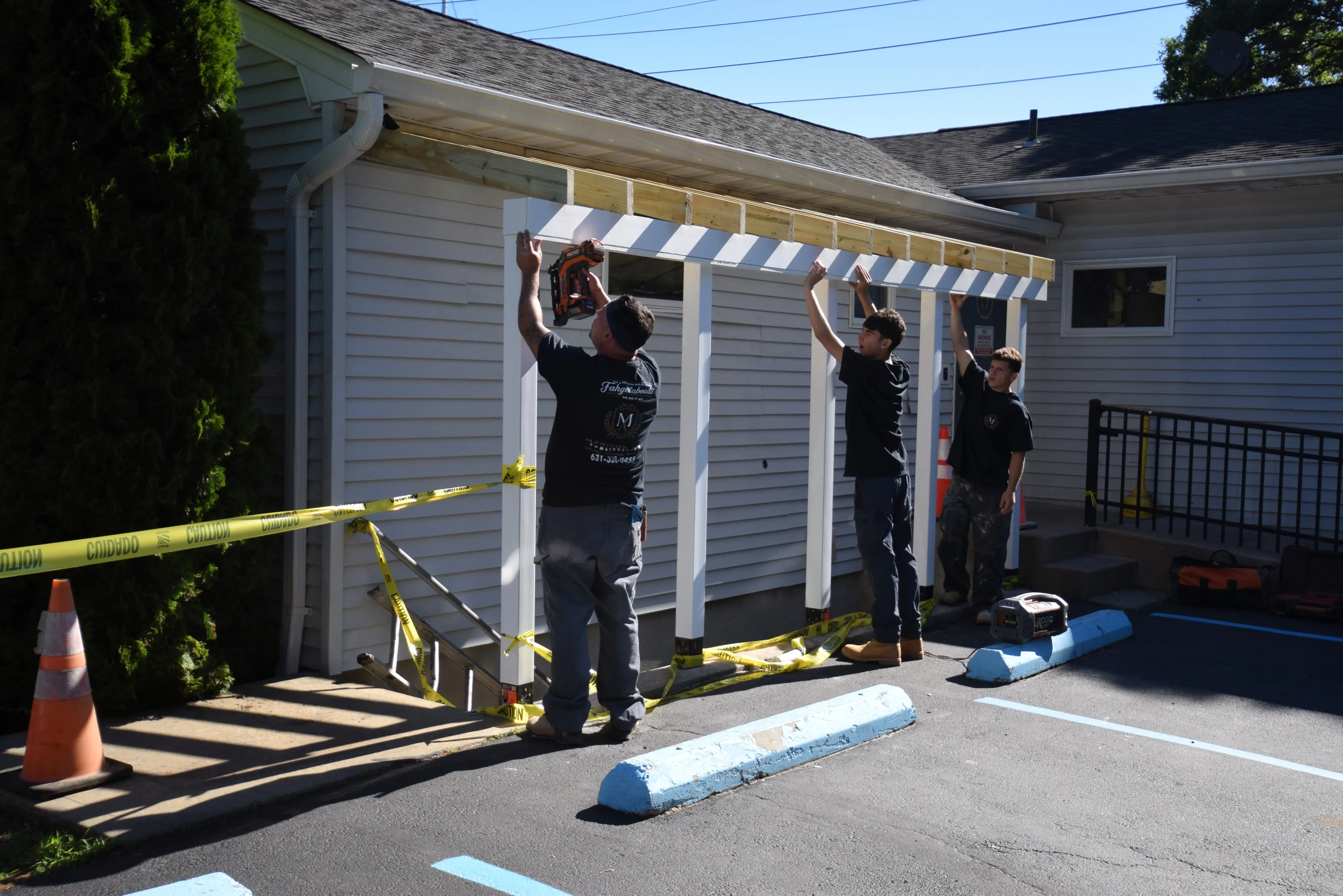 Madison Ave Construction crew building the new overhead canopy over the stairwell