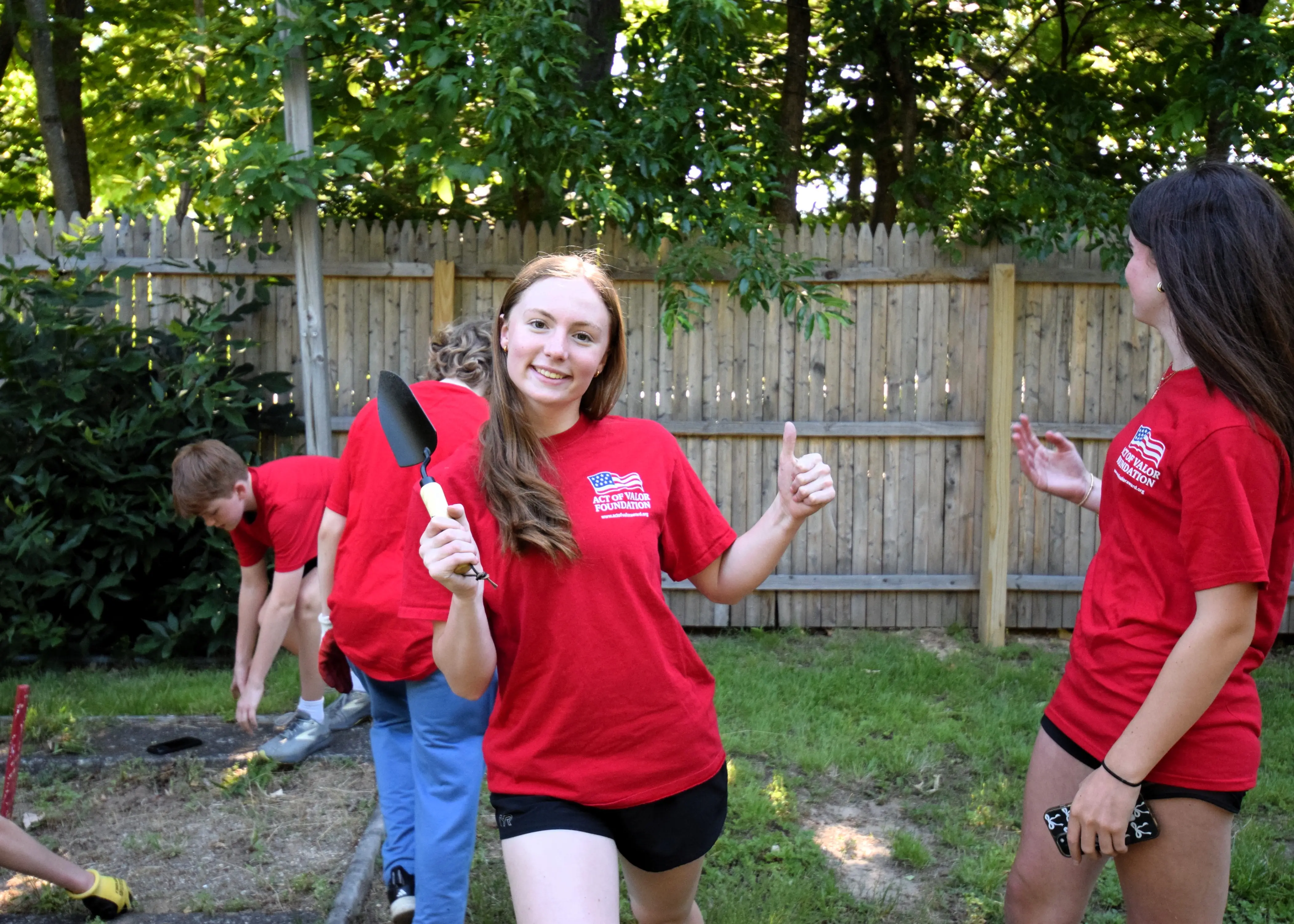 Youth volunteers celebrating at the American Legion community project