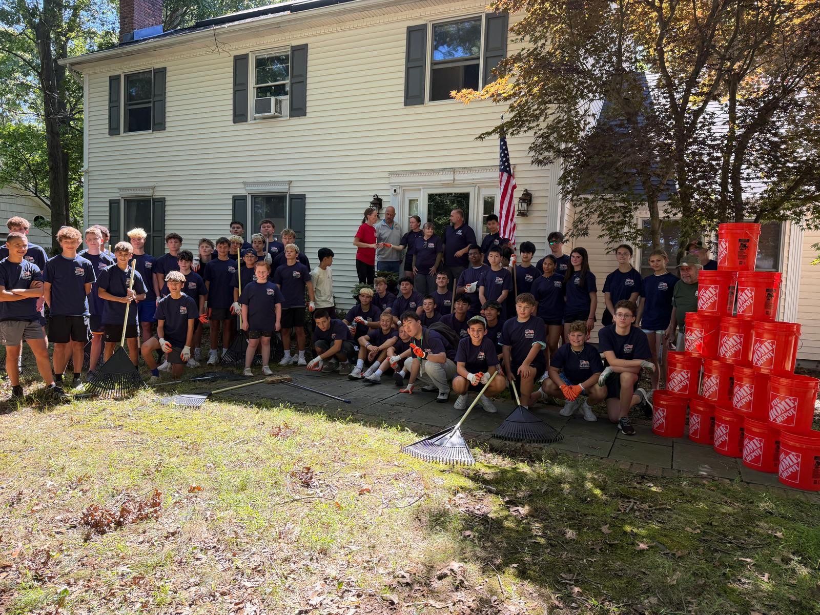 More than 50 student volunteers gathered in front of a local veteran's home during the Youths Helping Heroes at Home yard restoration in Setauket